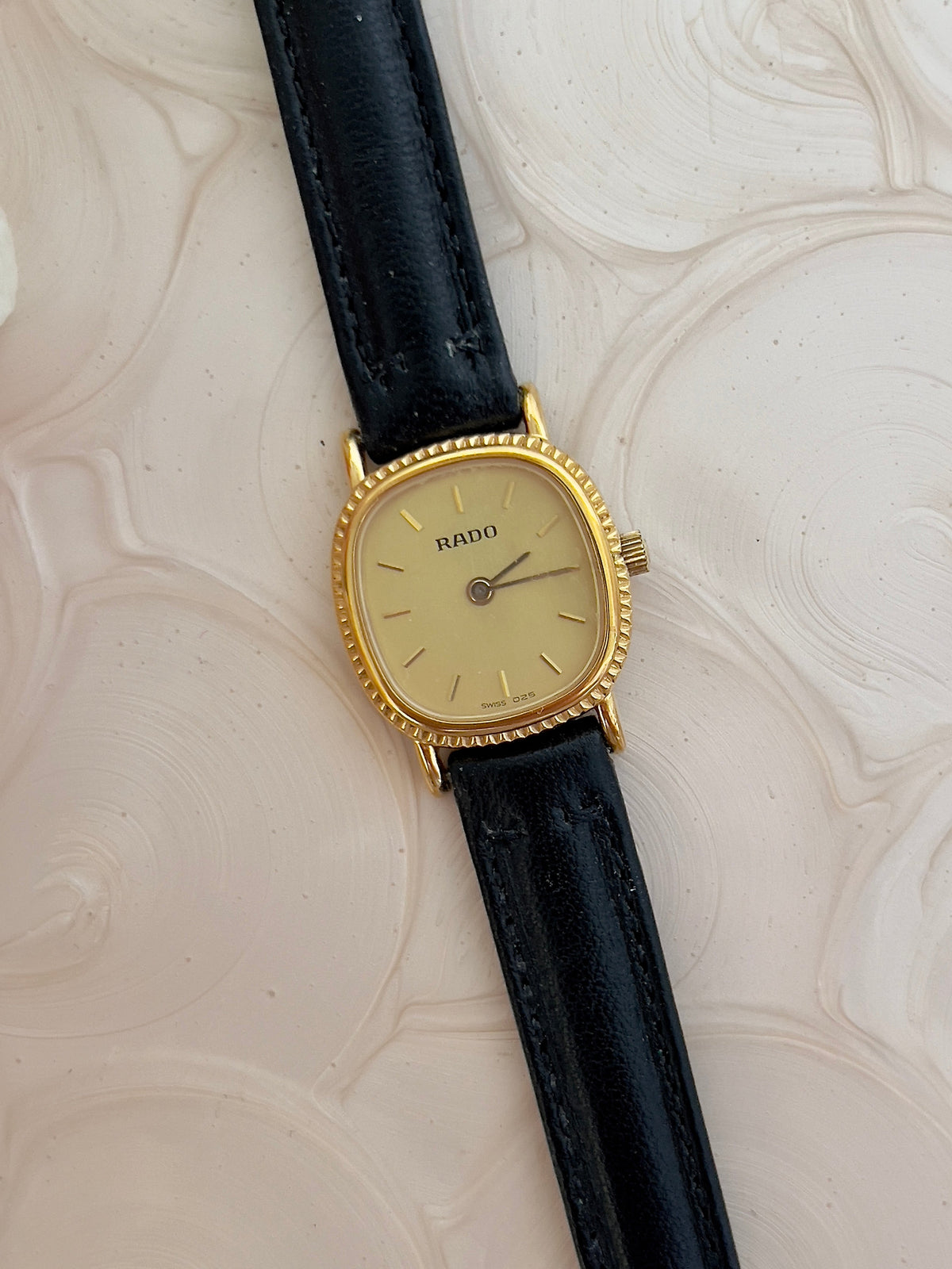 Rado Gold Cushion Women’s Watch with Fluted Case — front view of champagne dial.