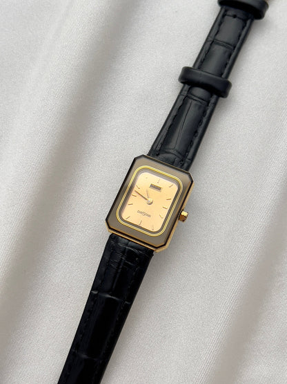 Vintage Rado DiaStar tank women's watch with a champagne dial and black leather strap, shown in an alternate front view.