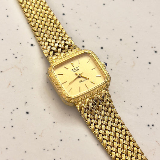 Vintage Rado Elegance rectangular women's watch with a champagne dial and gold mesh bracelet, shown in a detailed front view.