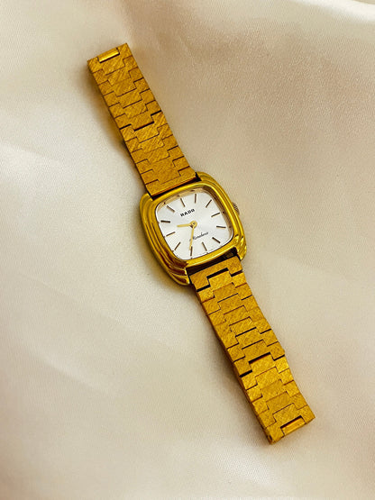 Vintage Rado Moncherie women's watch with a silver dial, double gold-tone frame and bracelet, shown full length with the bracelet.