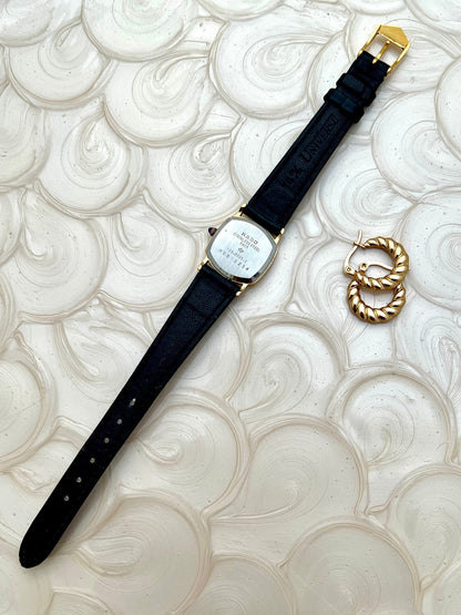 Vintage Rado Soft Octo Silhouette women's watch with a gold-tone case and black leather strap, shown from the back with the strap extended.