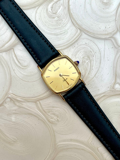 Vintage Rado Soft Octo Silhouette women's watch with a gold-tone case and black leather strap, shown in a detailed dial view.