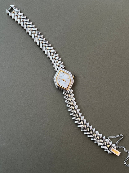 Vintage Rado two-tone sculpted women's watch with a pearl dial and herringbone bracelet, shown full length with the bracelet open.