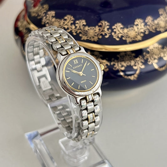 Vintage Seiko Lucent 1F21-0G90 women’s watch, dark navy dial and two-tone bracelet, angled view