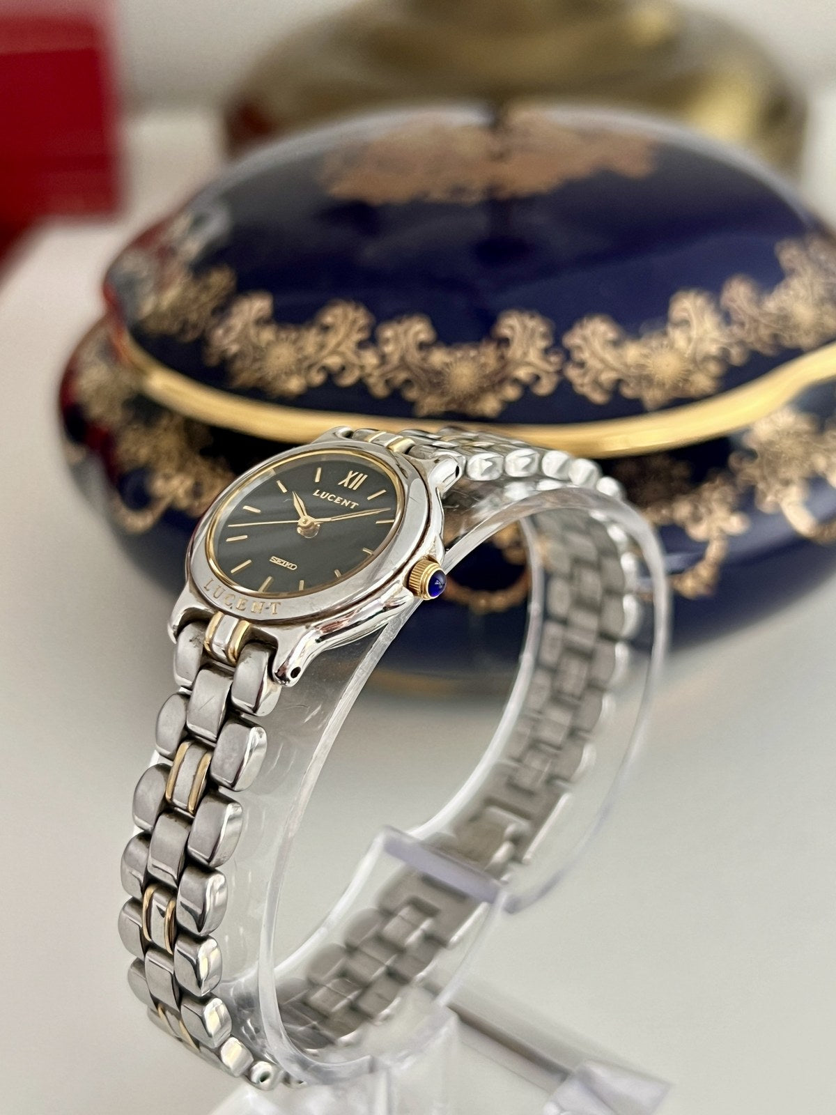Side view of Seiko Lucent two-tone women’s watch showing blue-tipped crown and bracelet