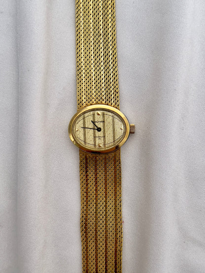 Waltham ladies watch with diagonal textured champagne dial and minimalist markers.