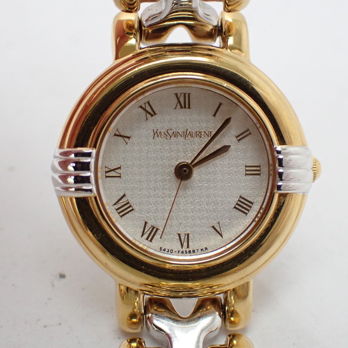 Front view of the Yves Saint Laurent 5430-F43071 with a silver Chidori-textured Roman numeral dial and two-tone bracelet