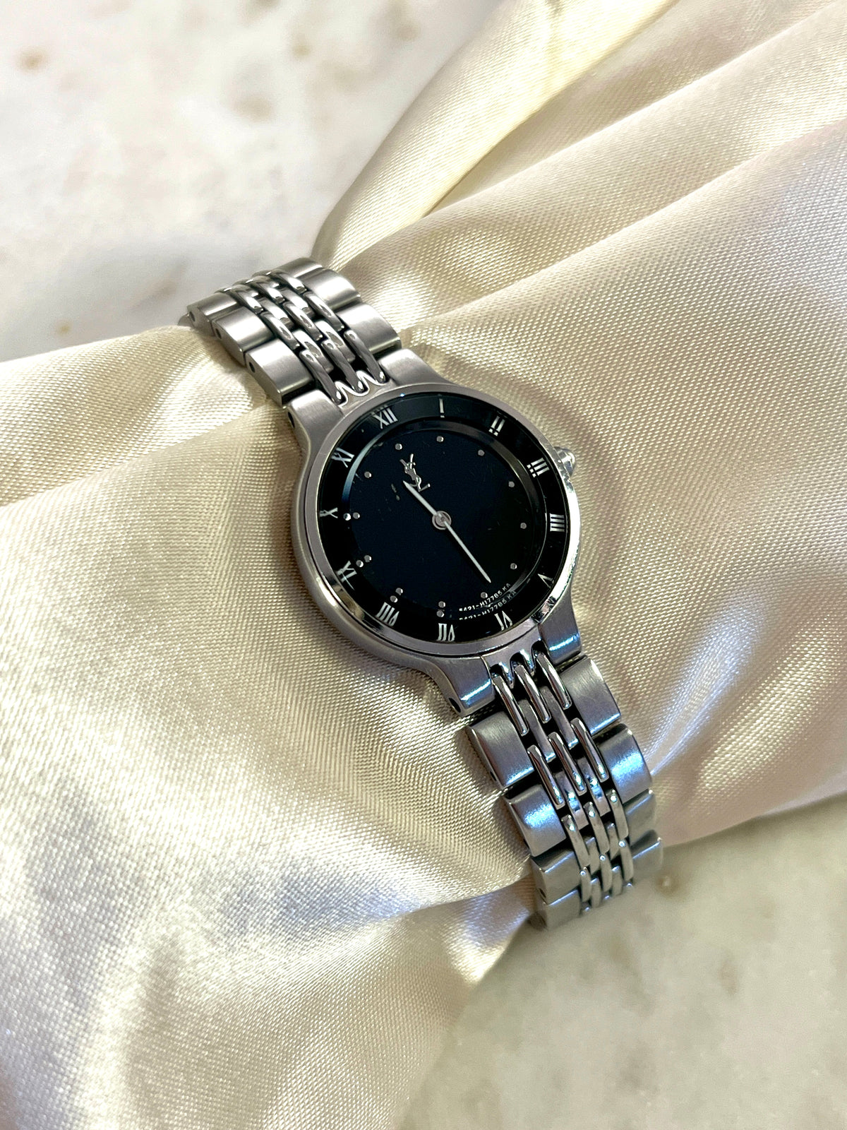 Yves Saint Laurent Black Dial Silver Bracelet Women’s Watch; silver tone bracelet with multiple rows of links. Product photograph 5 of 8.