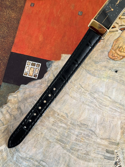 Black crocodile embossed leather watch strap with tonal stitching and adjustable pin buckle holes.
